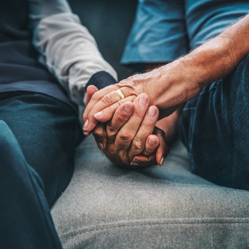 image of elderly couple holding hands