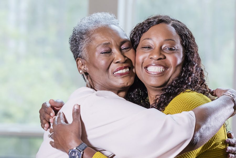 Senior African-American woman, adult daughter hugging