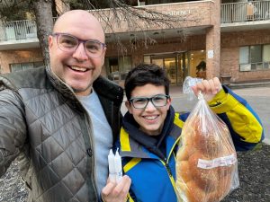 Asher Lichtman and his son deliver challah and candles to Jewish clients.