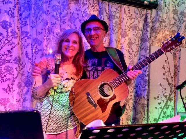 Client Gail and her husband Michael performing at an open mic night