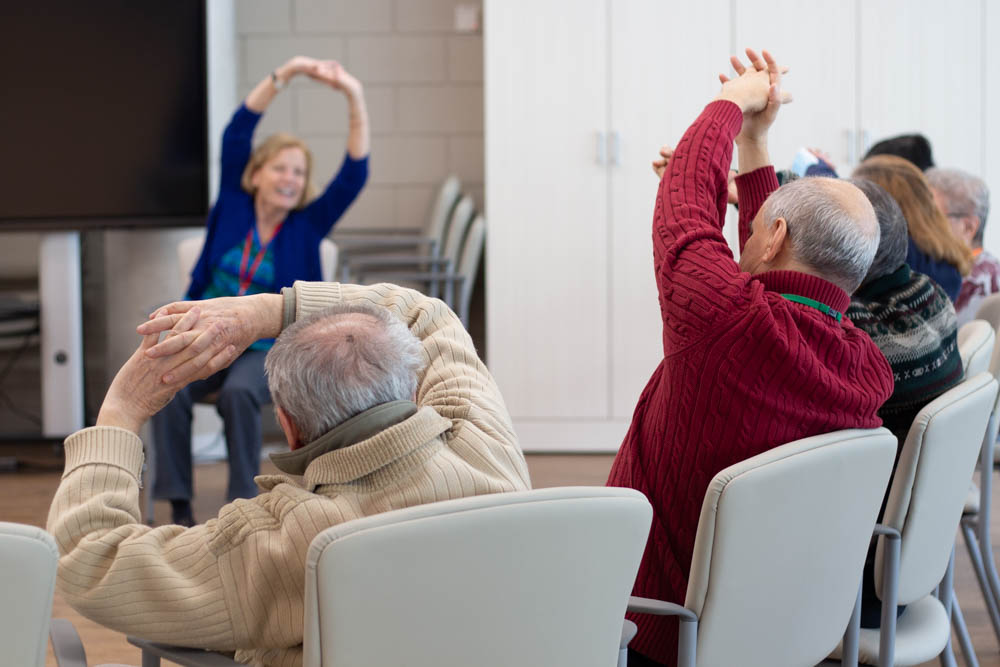 ADP clients participate in a seated yoga class